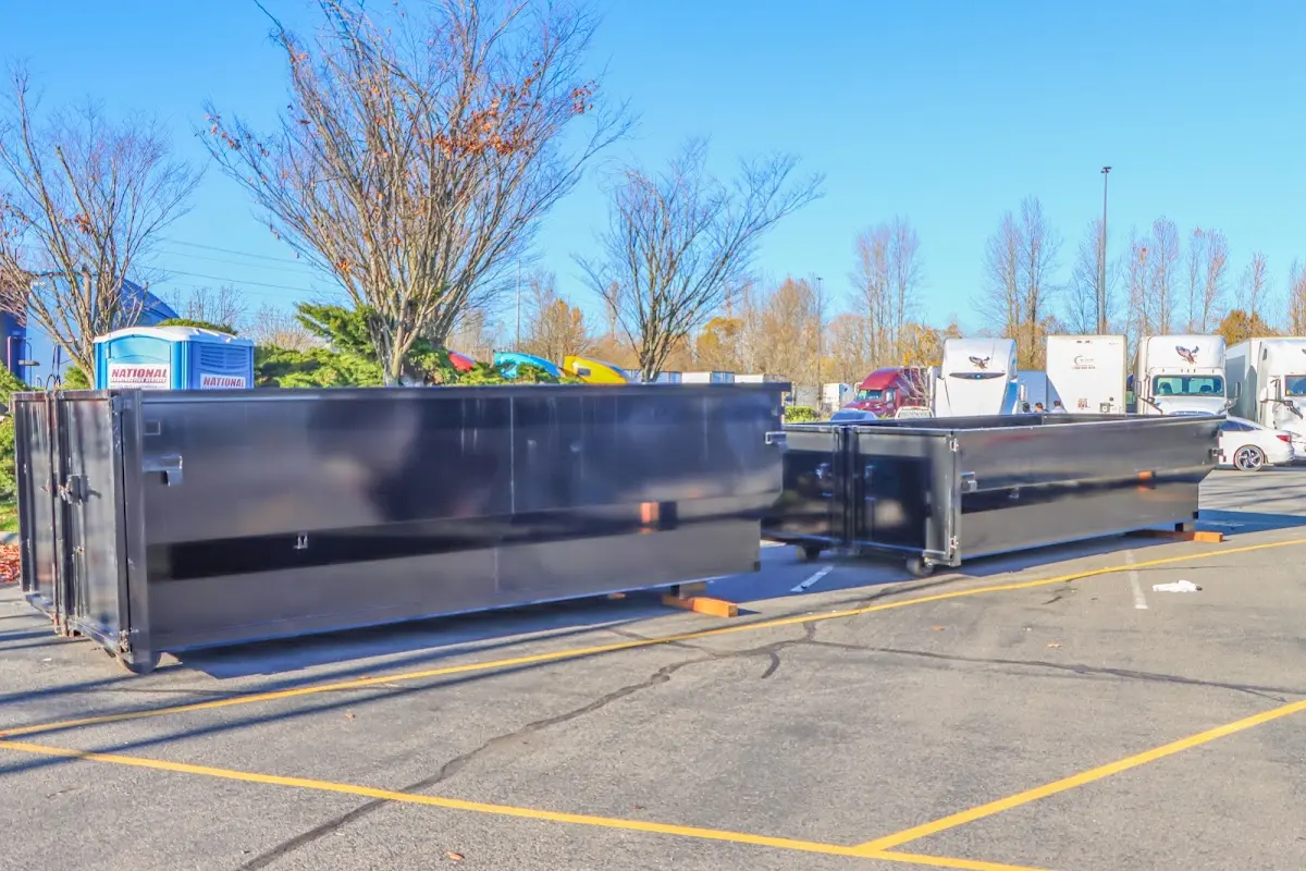 Professional dumpster rental service with roll-off container on residential driveway in Jefferson City